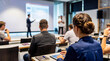© Olivia - Diverse audience attentively listens to a presenter during a professional business conference or educational seminar.