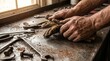 © nupixel - Close-up of dirty hands holding worn leather gloves on a workbench with tools. Perfect for Labor Day concepts, honoring hard manual work, industry, and rugged craftsmanship.