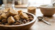 © Vero - Large unrefined brown sugar crystals and cubes in a rustic wooden bowl on a kitchen table with baking supplies like a whisk, mixing bowl, and measuring spoon in the background.