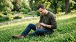 © FACTORY GRAPHICA  - Young Man Petting Tabby Cat While Sitting on Grassy Slope in Sunny Park