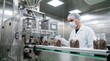© WisChi - Factory worker in cleanroom packaging coffee beans on automated production line