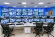 © whitestorm - Modern security control room with multiple monitors displaying live surveillance camera feeds.