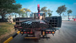 © thongdee - Workers preparing steel products for transportation on cargo truck in industrial yard, concept of logistics and construction materials delivery.
