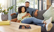 © peopleimages.com - Smile, black couple and relax with phone at house for social media, browsing website and bonding. Happy, people and mobile app for streaming video, download movies and subscription for weekend break