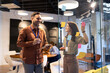 © littlewolf1989 - Business colleagues collaborating on creative ideas using sticky notes during a brainstorming session in a modern office