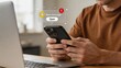 © Noah - Man holding smartphone receiving new email message notification bubble, digital communication concept, instant messaging alert, mobile app interface, social media connection and