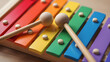 © PNG shops - This bright colorful musical xylophone with two wooden mallets is captured in a high quality professional studio product style photo