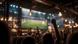 © JoaoNalio - Excited crowd cheering at a sports bar while watching a soccer match on TV