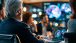 © Kateryna - A  investor team viewed from behind discusses soft AI innovations in a bright boardroom with calm glowing softly defocused presentations in soft daylight AI boardroom