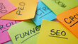 © Taohidul - Closeup of colorful sticky notes with marketing acronyms written on them