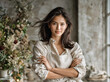© wing - A woman in a linen apron poses against a neutral grey background, her hair gently tousled by wind.