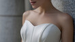 © photo for everything - Elegant female torso in a strapless white dress, close-up details showcase refined style and soft skin, perfect for beauty and fashion concepts