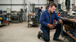 © Xenia - Male electrician wearing leather gloves and cutting a thick black cable with large pliers. Industrial worker performing maintenance in a workshop. Electrical repair and manual labor concept