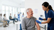 © Xenia - Smiling elderly man receiving a vaccination from a nurse. Senior patient getting an injection in a medical clinic. Healthcare and immunization concept