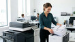 © Xenia - Smiling businesswoman taking printed papers from office copier. Female assistant organizing stack of documents by large printer in modern workplace