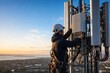 © Leo Rohmann - Telecom infrastructure maintenance with technician servicing wireless network equipment at sunset
