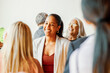 © Rawpixel.com - Smiling Black businesswoman networking with diverse professionals