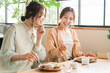 © buritora - Women enjoying a delicious lunch with their female friends/mom friends (girls' get-together)