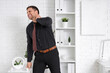 © Pixel-Shot - Businessman suffering from neck pain in office