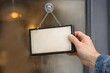 © Fotograf - Person holding sign hung from window with message or symbol