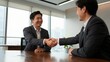 © mila103 - Businessmen shaking hands during meeting in office boardroom