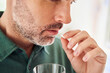 © Westend61 - Close-up of adult man taking pill