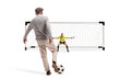© Ljupco Smokovski - Elderly man kicking a football towards a goal net