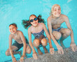 © Tatyana Gladskih - Kids having fun in swimming pool. Group of boy and girl playing in water. Happy children on summer vacation enjoying outdoor activity at resort. Aquatic leisure lifestyle concept.