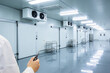 © Snide12 - Professional inspecting a sterile cold storage facility with climate control systems