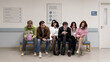 © Lustre Art Group  - Tired patients waiting in clinic hallway with stylish characters and healthcare service mood. Concept of medical waiting room, patient experience, healthcare access, appointment delay, and service ads