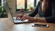 © rahwik - copywriter using laptop at wooden table indoors close up workspace concept
