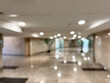 © ASDF - Long hallway with polished floors and recessed lights background