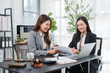 © Kritdanai - Legal Consultation: Two professional women in a law office discuss legal documents, with a gavel and scales of justice symbolizing the legal profession.