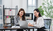 © Kritdanai - Consultation in Legal Office: Two professional women engage in a productive discussion over a laptop in a modern law office, surrounded by legal books, scales of justice, and a gavel.