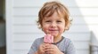 © MHS-AI - Close-up portrait of cute messy toddler boy eating pink strawberry popsicle with ice cream smeared on face and cheeks in backyard setting for family childhood lifestyle photography concept