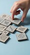 © alstok  - Hand Arranging Business Icon Tiles for Strategic Planning.