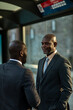 © Marko Geber - Two business professionals talking at urban transit station