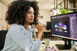 © Marko Geber - Woman graphic designer working on computer at modern office