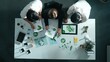 © InfiniteFlow - Top down view of business team discussing about renewable energy. Aerial view of skilled diverse business people working together to plan about zero waste while using laptop on table. Alimentation.