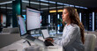 © Andrey Popov - Young Woman At Desk Using Laptop