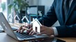 © Soyaeb - Real Estate Investment A Person Working on a Laptop with Icons of Houses and Percentages Symbolizing Property Growth and Financial Opportunities