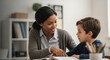 © Maksym - Educator guides elementary student reading a book at a desk