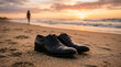 © MUHAMMAD - A moment of transition elegant shoes on the sand as a lone figure walks towards the serene ocean sunset