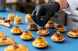© Reed - Chef garnishing gourmet appetizers