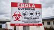 © Appleton Stock - Ebola outbreak warning sign outdoors with biohazard symbol and public health safety instructions in an emergency quarantine environment