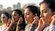 © Luiz - Group of women putting on headphones before running together outdoors, focused and motivated. Concept of fitness, unity, energy drive.