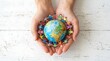 © Wahyuprt - World Population Day Concept with Hands Holding Globe and People