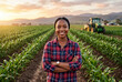 © Meow Creations - Confident african american woman farmer standing with crossed arms in a green agricultural field