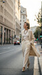© Not_nutthapong - Elegant woman city street fashion beige coat trousers high heel urban stylish walking sunlight female adult business confident modern portrait