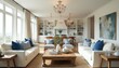 © Pete - Elegant coastal living room features white sofas, blue accent pillows, natural wood coffee table, and built-in shelving. Open space with large windows, chandeliers, and abstract wall art.